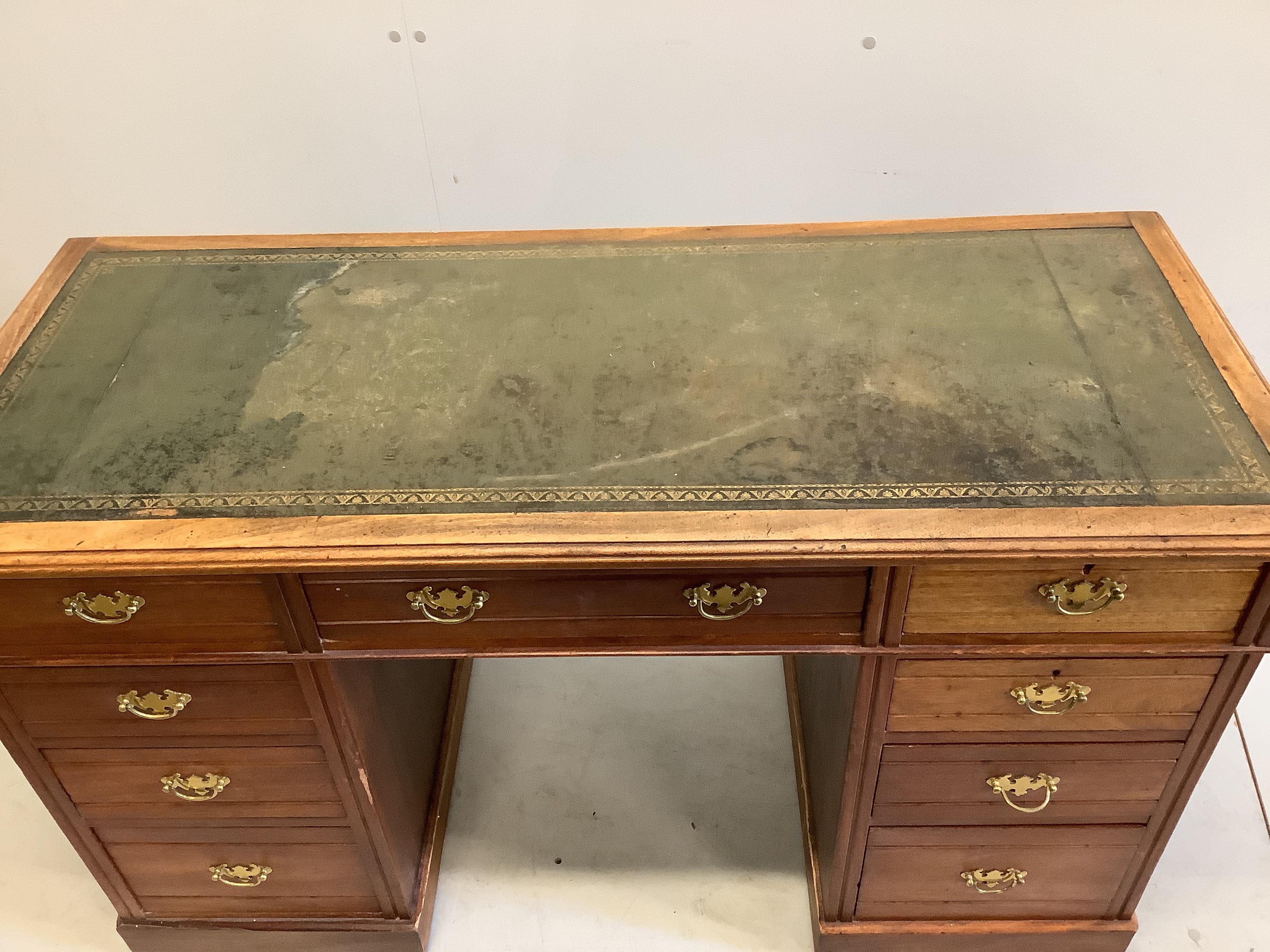 A late Victorian mahogany kneehole writing table, fitted nine small drawers, width 130cm, depth 55cm, height 78cm